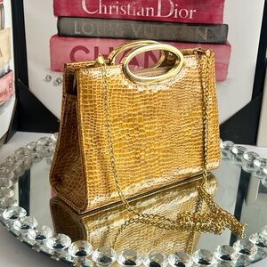 Bellini gold faux snakeskin purse with a detachable chain strap.